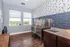 Chic pet wash station with modern blue tile accents, natural light, and stylish wood flooring.