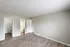 Bright bedroom with elegant wood flooring, featuring convenient access to a bathroom and utility room, ideal for modern living.