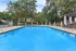 Inviting outdoor pool surrounded by lush greenery, perfect for relaxation and recreation.