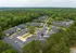 Aerial view of a serene apartment complex surrounded by lush greenery, offering ample parking and spacious living conditions.