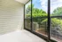 Bright and airy screened patio with lush green views, perfect for relaxing and enjoying the outdoors.