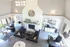 Inviting living space with high vaulted ceilings, a striking stone fireplace, and elegant decor blending modern and cozy styles.