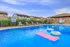 Inviting outdoor swimming pool with lounge chairs and fun inflatables, perfect for relaxation and summer enjoyment.