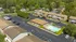 Charming apartment complex with lush greenery, ample parking, and a sparkling pool, perfect for a serene lifestyle.