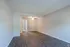 Bright and inviting empty room featuring sleek hardwood flooring and modern light fixtures, ideal for customizing your space.