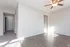 Bright apartment showcasing a modern interior with sleek wood flooring and a stylish ceiling fan.