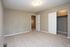 Inviting empty room with plush carpet, neutral walls, and a spacious closet ready to personalize.