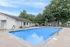 Inviting outdoor swimming pool surrounded by lush greenery and comfortable lounge chairs.