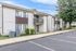 Modern suburban apartment complex with charming balconies and lush greenery, offering spacious parking and inviting community living.