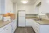 Bright kitchen with modern white cabinetry, granite countertops, and sleek appliances.