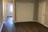 Inviting entryway with stylish hardwood flooring, ample closet space, and natural light from an adjacent room.