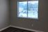 Bright, fresh apartment interior featuring a large window with natural light and an inviting view, perfect for creating a cozy home ambiance.