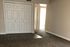 Inviting apartment interior showcasing a spacious bedroom with plush carpeting and ample closet space.