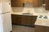 Charming kitchen with modern white appliances, elegant wooden cabinets, and sleek countertops.