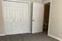 Inviting bedroom with plush carpeting, dual closet doors, and an en-suite bathroom entrance, ready for comfortable living.