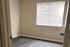 Bright and inviting room with natural light filtering through blinds, perfect for a cozy bedroom or home office.