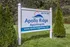 Inviting entrance sign for Apollo Ridge Apartments set against lush greenery, offering a welcoming community vibe.