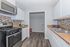 Modern kitchen with sleek appliances, stylish tile backsplash, and elegant countertops featuring ample cabinet storage.