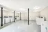 Bright and spacious laundry room equipped with multiple washing and drying machines, offering convenience and efficiency.
