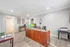 Inviting office space with a wooden desk, colorful balloons, and ample natural light, perfect for productive workdays.