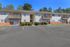 Charming two-story apartment building with private balconies and well-maintained landscaping, offering a welcoming atmosphere in a peaceful neighborhood setting.