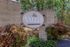 Inviting entrance sign of 'The Valley' at 1823 & 1826 Biscayne Place, surrounded by lush greenery and vibrant landscaping.