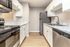 Modern kitchen with sleek marble countertops, stainless steel appliances, and elegant cabinetry.