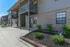 Charming apartment exterior with beautiful brick facade, inviting balconies, and meticulously landscaped garden.