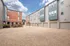 Contemporary townhouse complex with sleek architectural design, featuring large windows and spacious garages, under a clear, vibrant sky.