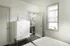 Bright and cozy bedroom featuring modern white furniture, an inviting gray wood floor, and a soft quilted bed, perfect for relaxation.