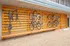 Modern apartment bike rack showcasing secure and stylish storage facility for multiple bicycles against a wooden paneling backdrop.