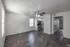 Bright and cozy living space with elegant wooden flooring and modern kitchen appliances, ideal for comfortable living.