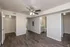 Modern apartment bedroom with elegant wood flooring, spacious closet, ceiling fan, and attached bathroom for enhanced comfort.