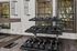 Chic apartment gym featuring modern weight racks with expansive windows for natural light.