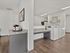 Modern laundry room with sleek washing machines and a convenient coffee station.
