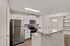 Modern kitchen with sleek stainless steel appliances, granite countertops, and elegant cabinetry, ideal for culinary enthusiasts.