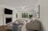 Bright and airy living room featuring a cozy fireplace, elegant sofa set, and modern decor with large windows offering scenic views.