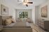 Inviting bedroom with modern decor, featuring a cozy bed, elegant artwork, and a charming seating area by a sunlit window.
