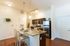 Inviting kitchen with granite countertops, stainless steel appliances, and cozy bar seating, perfect for entertaining.