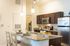 Modern kitchen with elegant granite countertops, complete with stainless steel appliances and stylish pendant lighting.