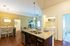 Modern kitchen with granite countertops, open dining area, and in-unit laundry offering convenience and style.