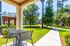 Charming apartment patio offering a picturesque view of landscaped gardens and a peaceful outdoor setting.