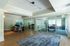 Modern office space with elegant glass partitions, chic furnishings, and abundant natural light.