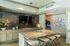 Elegant kitchen with granite island, chic mosaic backsplash, and modern appliances. Perfect for entertaining.