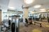 Modern fitness center with state-of-the-art exercise equipment, vibrant lighting, and mirrored walls for an energizing workout experience.