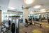 Modern fitness center with state-of-the-art equipment, mirrored walls, and natural light for an energizing workout experience.