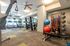 Modern fitness center featuring state-of-the-art gym equipment, treadmills with window views, and vibrant exercise balls for a dynamic workout experience.