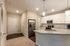 Elegant modern kitchen with stainless steel appliances, sleek granite countertops, and ample white cabinetry offering a bright and inviting atmosphere.