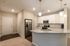 Elegant kitchen space featuring granite countertops, stainless steel appliances, and modern cabinetry in a cozy apartment setting.