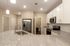 Modern kitchen with sleek granite countertops, stainless steel appliances, and elegant lighting.